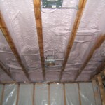 Advanced Insulation foam applied to ceiling of lower level basement for in floor heat on top of main level above